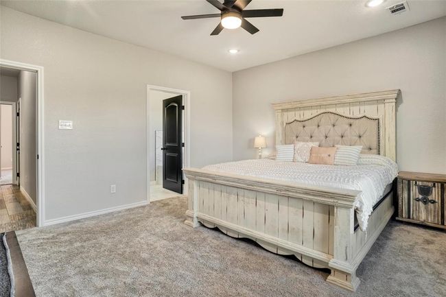 Bedroom with carpet, ensuite bath, and ceiling fan | Image 20