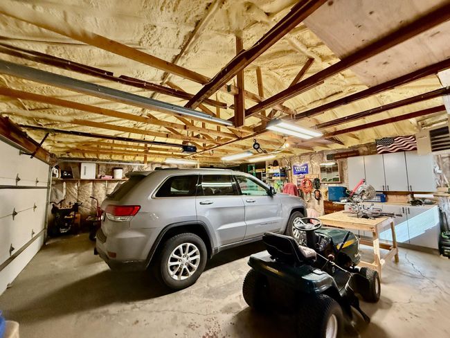 Spray foam insulated ceiling and heated garage with electrical and work bench | Image 31