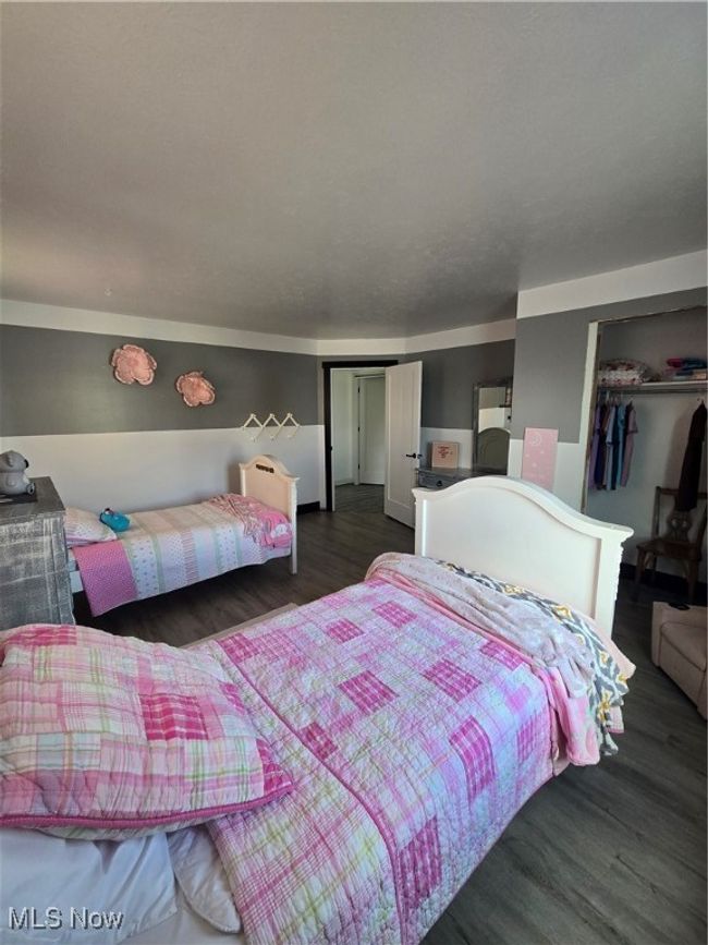 Bedroom featuring wood finished floors | Image 21
