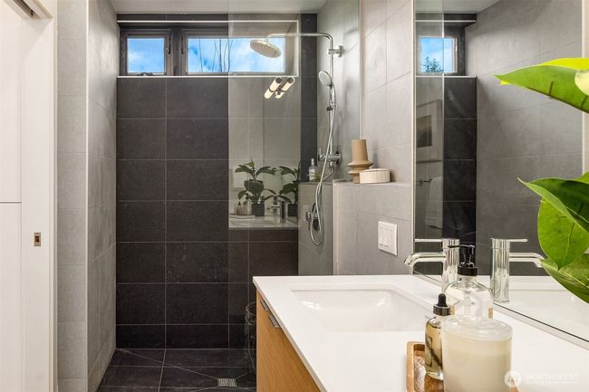 The main floor ensuite is thoughtfully designed with age-in-place features, such as a curbless shower, ensuring accessibility and convenience for all ages. | Image 12