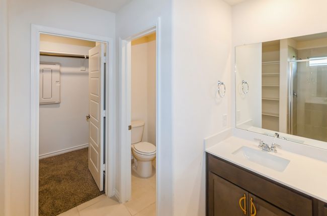 Full bath featuring electric panel, vanity, a stall shower, toilet, and tile patterned floors | Image 11
