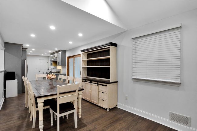 Dining area with recessed lighting, lofted ceiling, dark wood-style floors, visible vents, and baseboards | Image 9