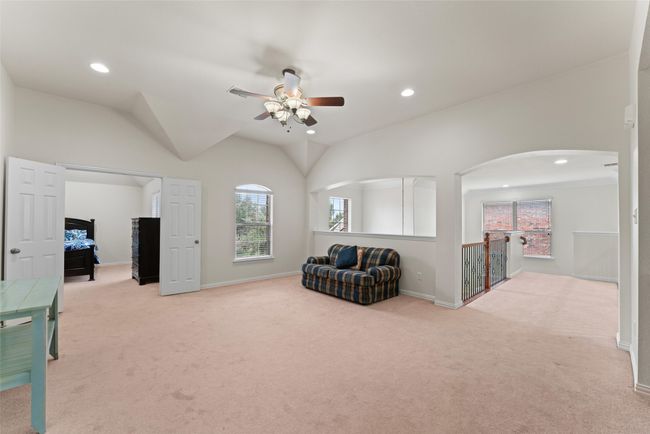 Sitting room featuring a ceiling fan, healthy amount of natural light, carpet floors, recessed lighting, and vaulted ceiling | Image 22
