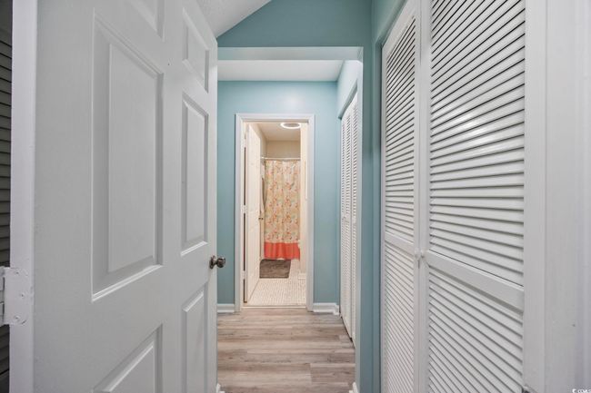 Hallway featuring light wood-style floors and baseboards | Image 15