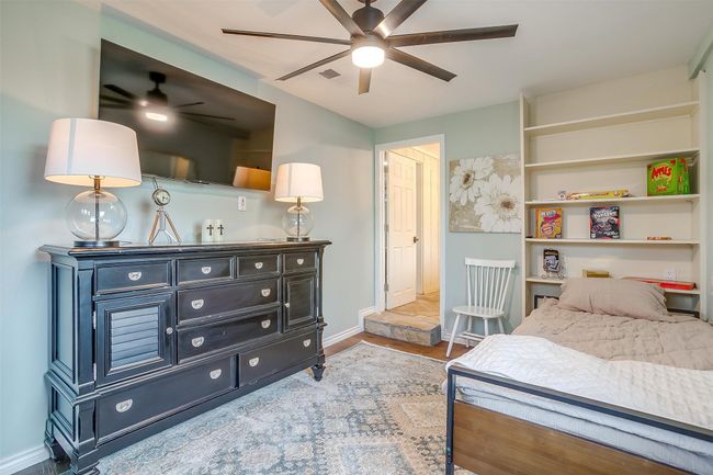 Bedroom with baseboards, a ceiling fan, and wood finished floors | Image 32