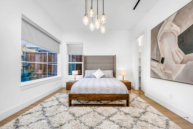 Bedroom featuring a chandelier and light wood-type flooring | Image 5