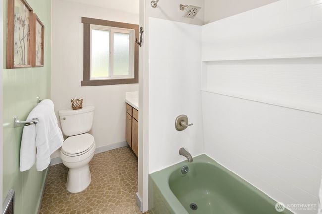 Bathroom with updated shower surround and vanity sink. | Image 17