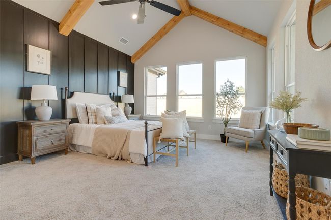 Carpeted bedroom with beamed ceiling, high vaulted ceiling, and ceiling fan | Image 17