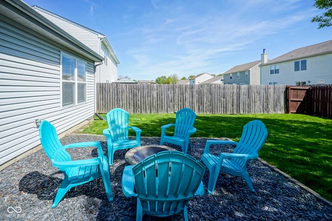 view of yard featuring an outdoor fire pit and a fenced backyard | Image 33