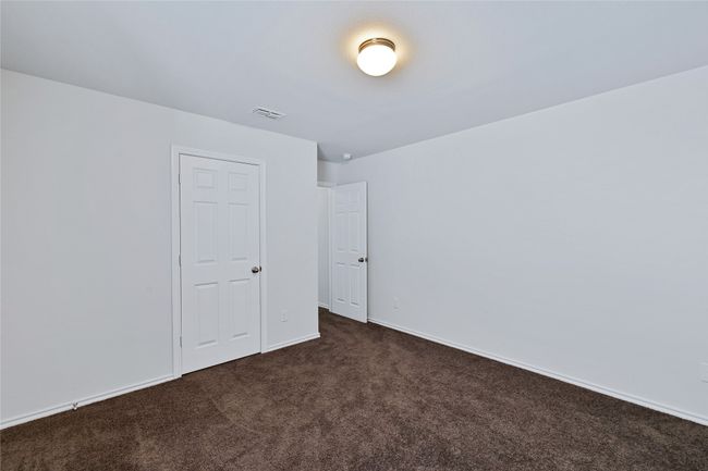 Unfurnished room featuring dark carpet and baseboards | Image 28