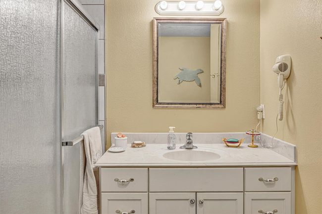 The bath room has a solid surface vanity top with molded in sink. | Image 17