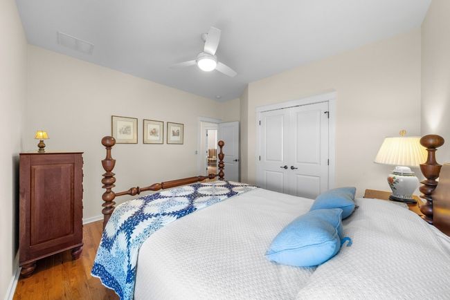 Bedroom with a closet, light wood-style floors, ceiling fan, baseboards, and visible vents | Image 27