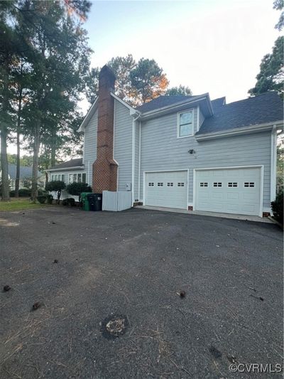 View of side of home featuring a garage | Image 2