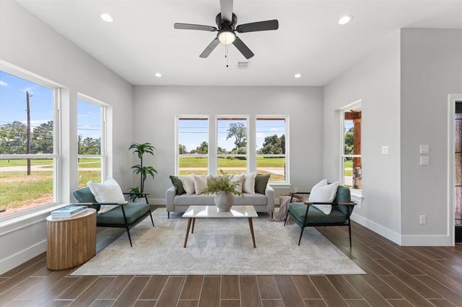Airy open living room with large windows. | Image 9