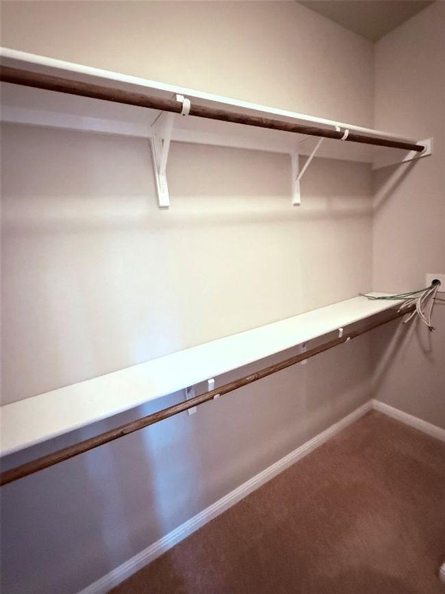Walk in closet featuring carpet floors | Image 9