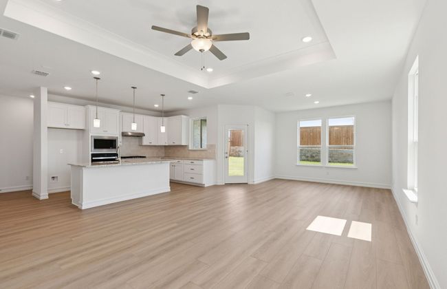 Expansive gathering room bathed in natural sunlight *Real home pictured | Image 11