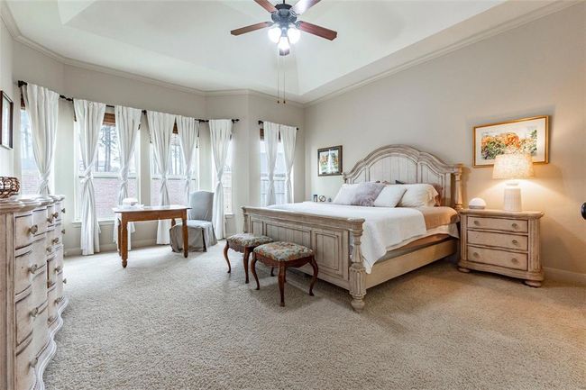Huge primary bedroom with new carpet, high ceilings, sitting area, and large windows with backyard views. | Image 33