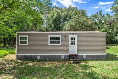 Welcome Home!...Newly Renovated w/ NEW Roof, NEW HVAC, NEW Vinyl Siding, NEW Windows & Doors and NEW Concrete Skirting | Image 1