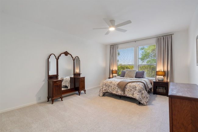Bedroom featuring light carpet, baseboards, and ceiling fan | Image 29
