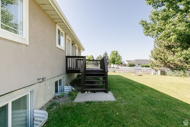 View of yard with a wooden deck and stairs | Image 26