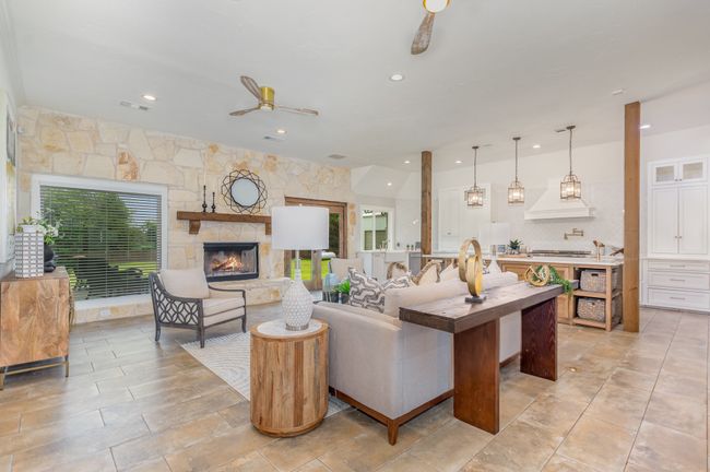 Living area with recessed lighting and a stone fireplace | Image 6