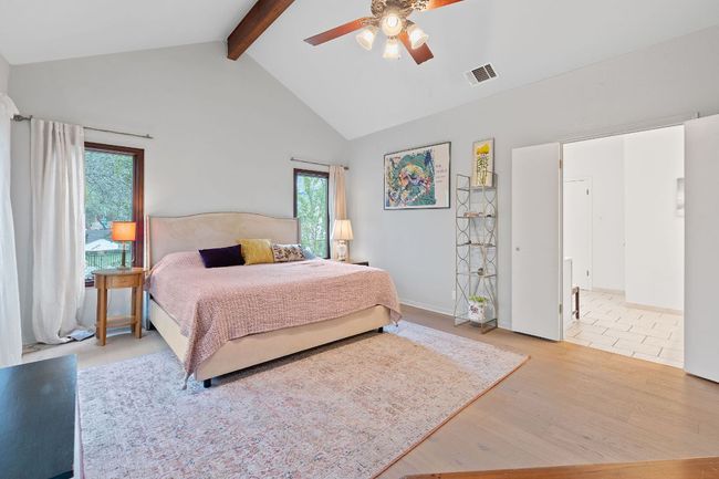 Bedroom with beam ceiling, wood finished floors, high vaulted ceiling, and ceiling fan | Image 18