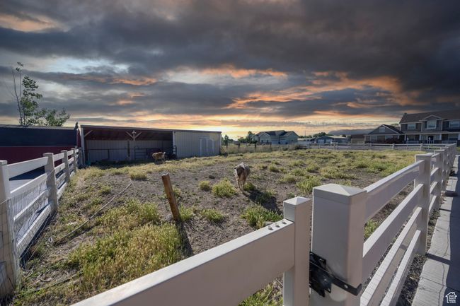 Yard at dusk with an outbuilding and an outdoor structure | Image 98