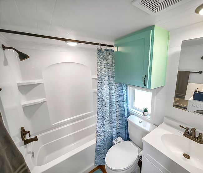 Bathroom featuring shower / bathtub combination with curtain and vanity | Image 28