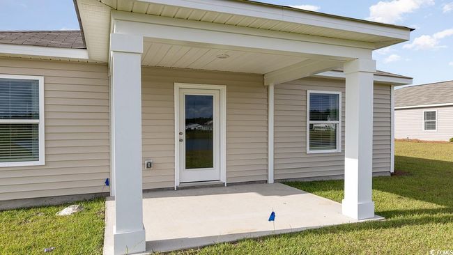 Doorway to property with a patio and a lawn | Image 24