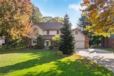 View of front of house featuring a garage and a front lawn | Image 1