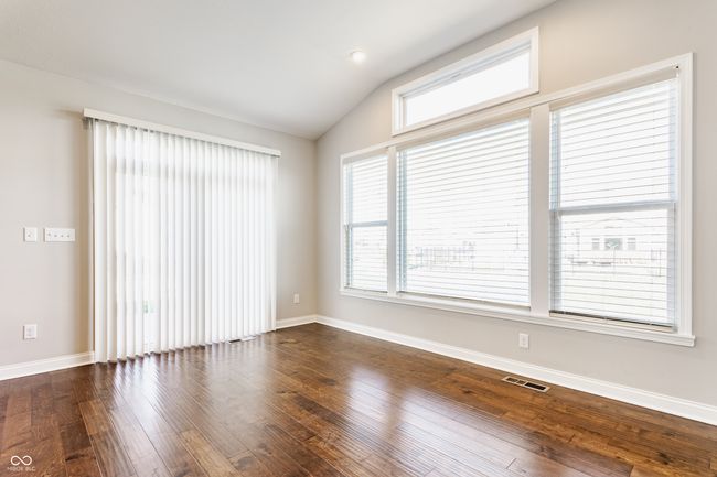 unfurnished room with lofted ceiling, baseboards, visible vents, and dark wood-style flooring | Image 23