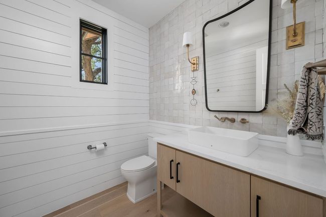 Bathroom with wood finished floors, tile walls, toilet, and vanity | Image 24