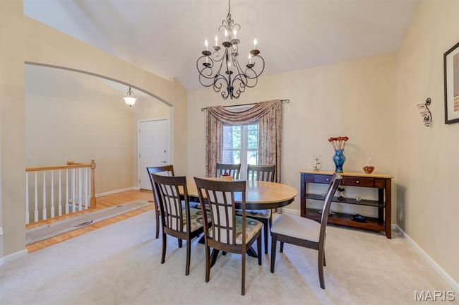 There is a small foyer that leads right into the formal dining room with arched entry and chandelier. | Image 4