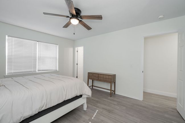 Bedroom with wood finished floors and ceiling fan | Image 20