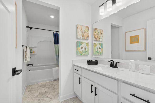 (Photo of a decorated model, actual homes finishes will vary) This stunning full bath is one of two baths located on the home’s upper level. | Image 16