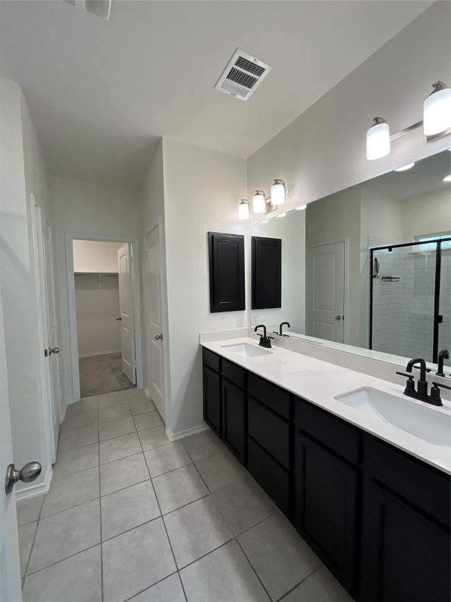 Full bath featuring a sink, tile patterned floors, a stall shower, and visible vents | Image 15