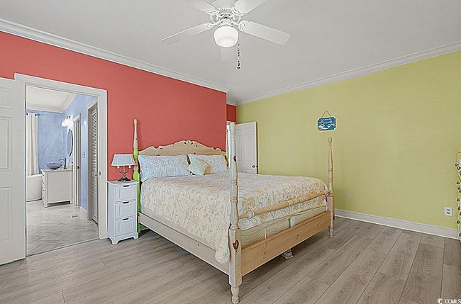 Bedroom featuring baseboards, light wood-style flooring, ornamental molding, and a ceiling fan | Image 25
