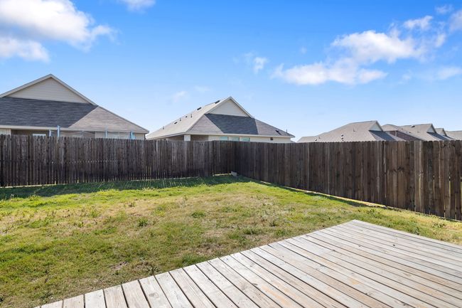Wooden terrace featuring a fenced backyard and a lawn | Image 20