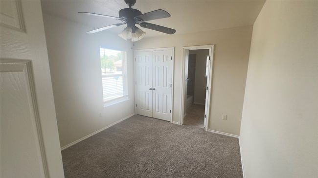 Unfurnished bedroom with carpet floors, a closet, ceiling fan, and connected bathroom | Image 13