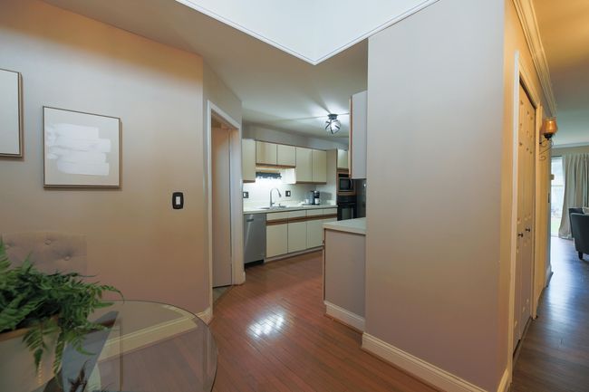 View of kitchen from main entryway opens to the dining area. | Image 7