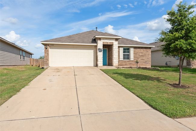 View of front of home featuring brick siding, driveway, a garage, and roof with shingles | Image 24
