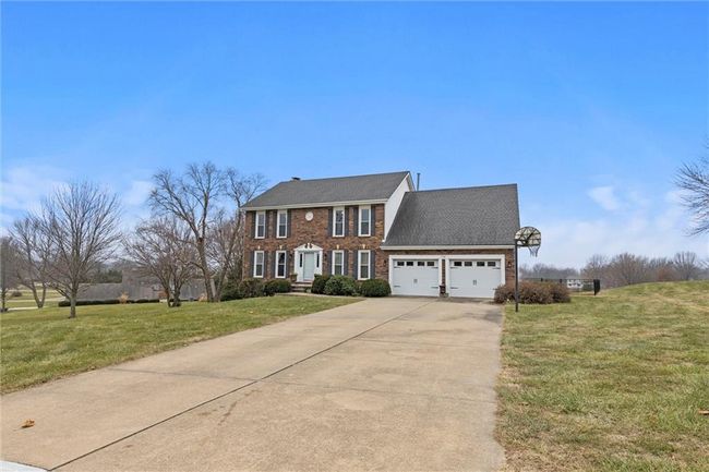 Colonial home with a garage and a front lawn | Image 4