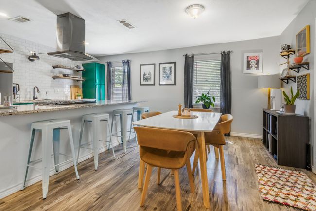 Dining room featuring healthy amount of natural light and light wood-style floors | Image 9
