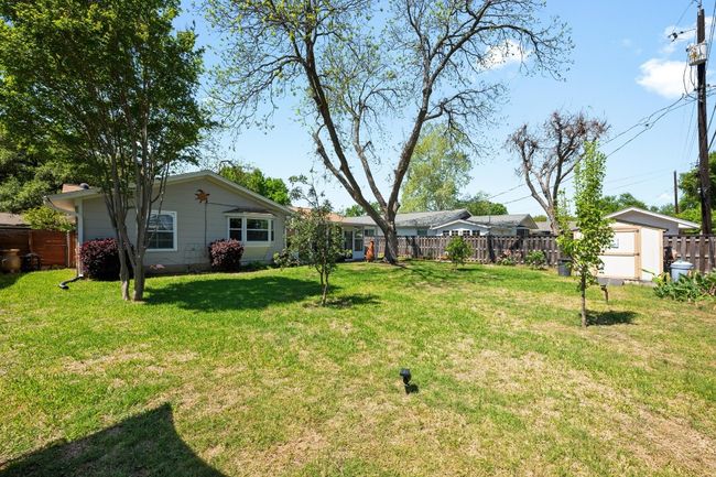 View of yard featuring an outdoor structure and fence | Image 26