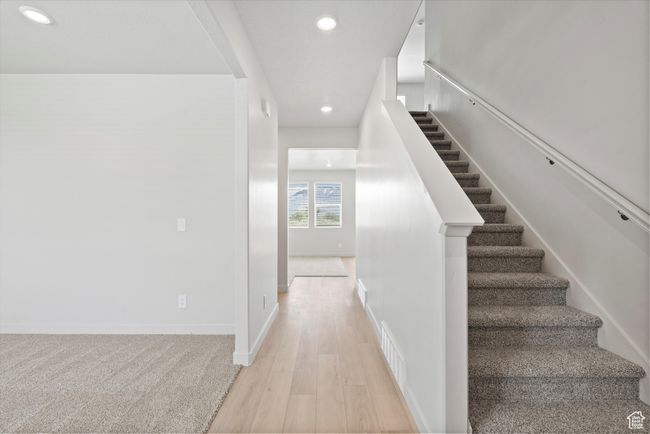 Staircase with recessed lighting and wood finished floors | Image 9
