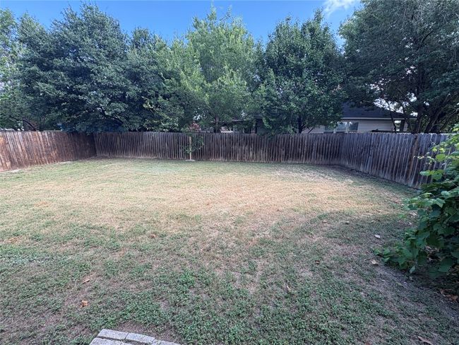 View of fenced backyard | Image 19