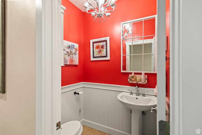 Bathroom featuring a chandelier, tile patterned floors, and toilet | Image 54