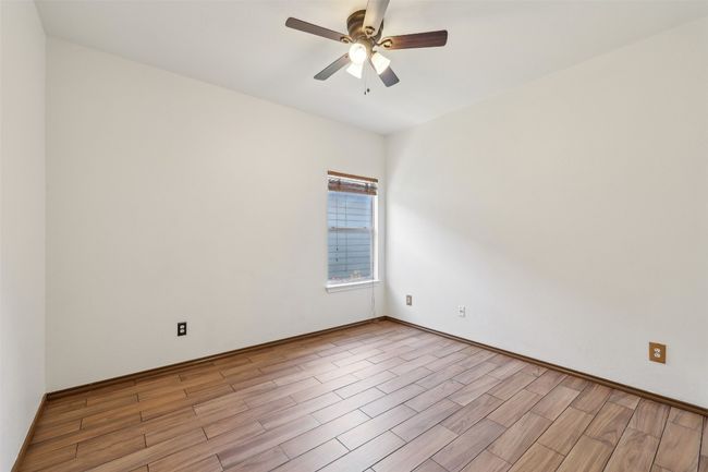 Unfurnished room featuring light wood-type flooring and a ceiling fan | Image 14
