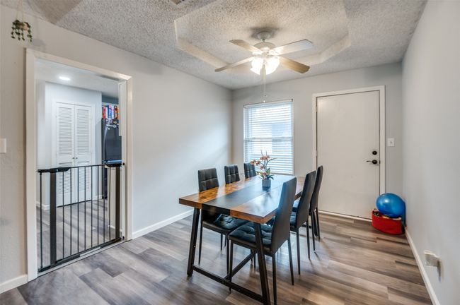 Dining area featuring a ceiling fan, wood finished floors, and a textured ceiling | Image 10