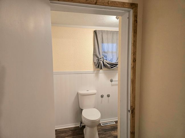 Bathroom featuring wood-type flooring and toilet | Image 17